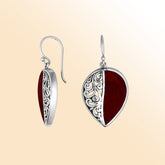 Teardrop silver earrings featuring vivid Red Coral and ornate Bali scrollwork.